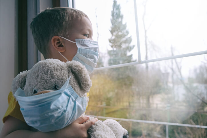 boy with mask COVID pandemic kid with a mask on holding teddy bear